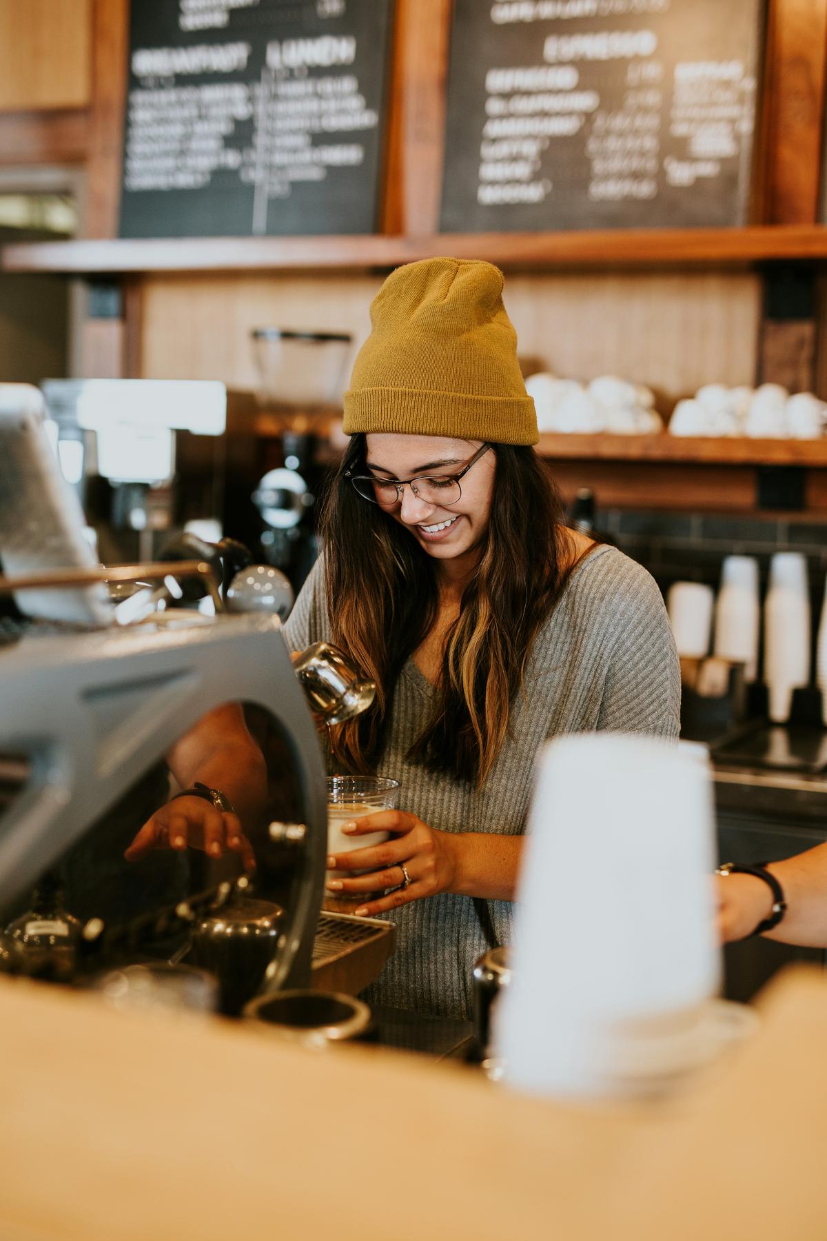 Smiling barista crafting a drink